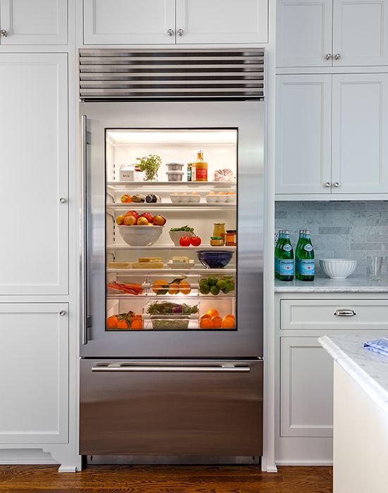 A glass door fridge is a cool idea for a contemporary space, though it needs more maintenance, it instantly adds a modern feel.