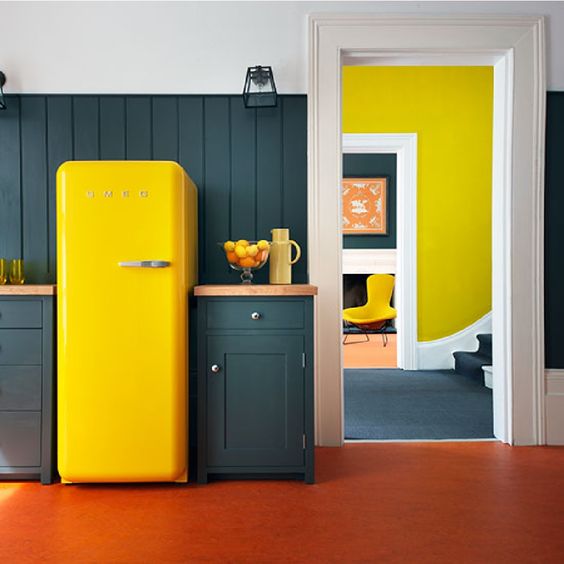 A graphite grey kitchen with a sunny yellow Smeg fridge for a bold statement.