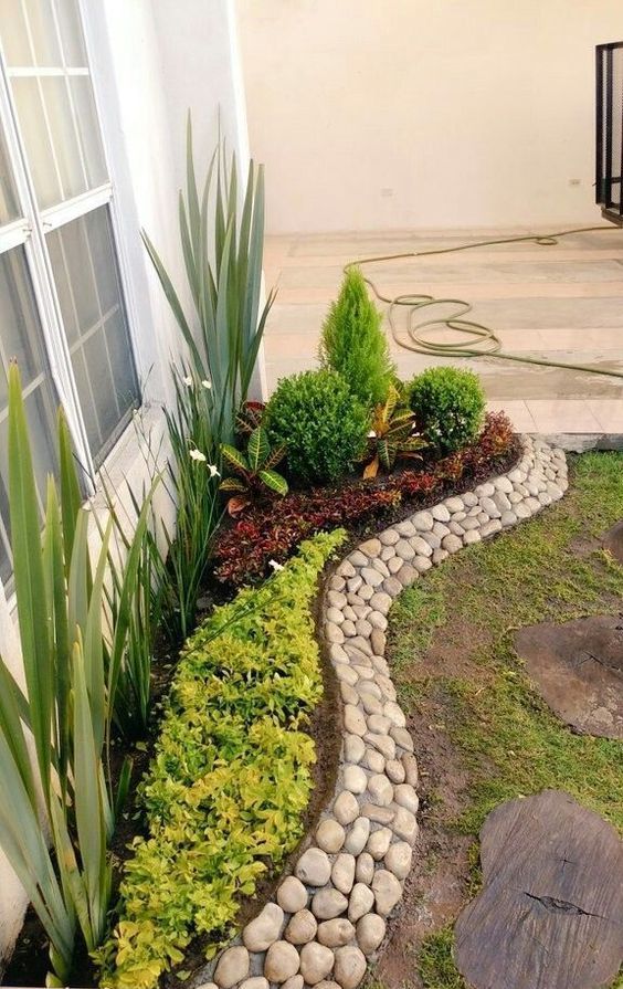 A stylish and creative pebble border is a cool way to add texture and interest to your raised garden bed.