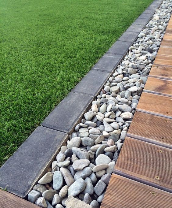 A pebble and dark brick border will fit a modern garden and will make it look edgy and stylish.