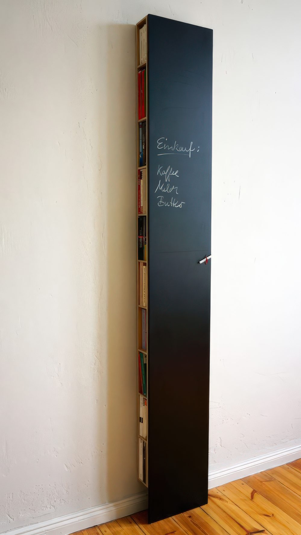 A tall and thin chalkboard storage unit hiding books, magazines and a wi-fi router can double as a note board or an art one.