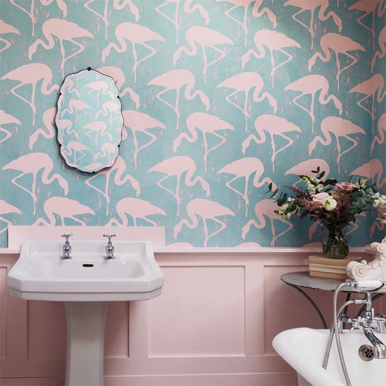 pink molding panels and matching flamingo printed wallpaper create a chic tropical feel.
