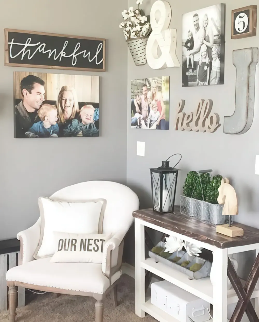 A small nook with a comfy chair, a console table and family photos and signs all over.