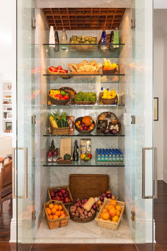 A large fridge with glass doors and glass shelves is a great extra display and it will make the kitchne fele more open.