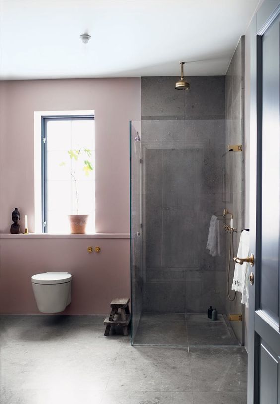 The contrast between pink walls and grey concrete is striking and the space doesn't look too glam and girlish.