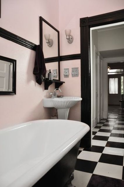 Pink walls, black detailing and black and white checked floors create a chic vintage space.