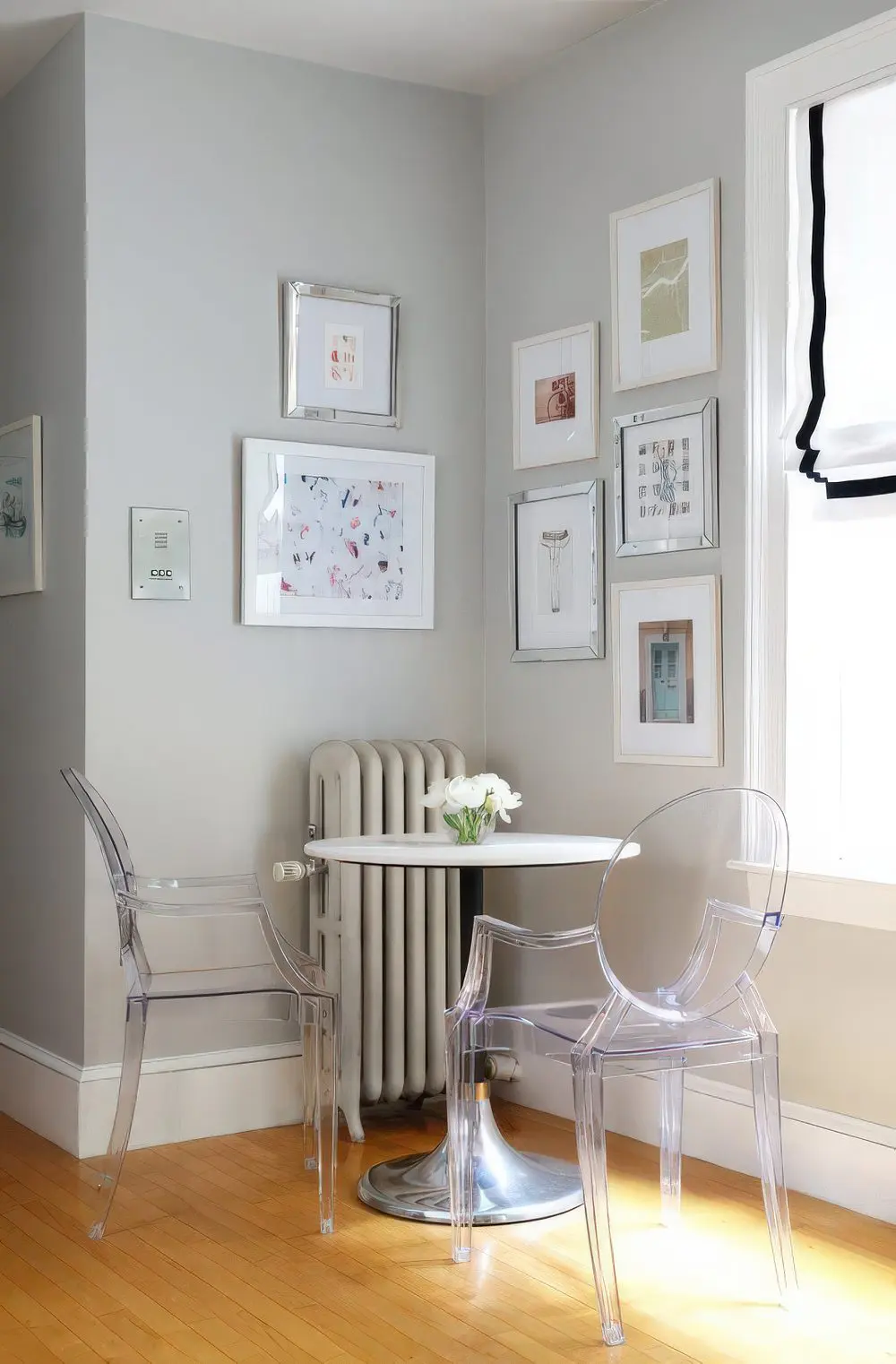 A small breakfast space with a round table and acrylic chairs looks airy and very comfy.