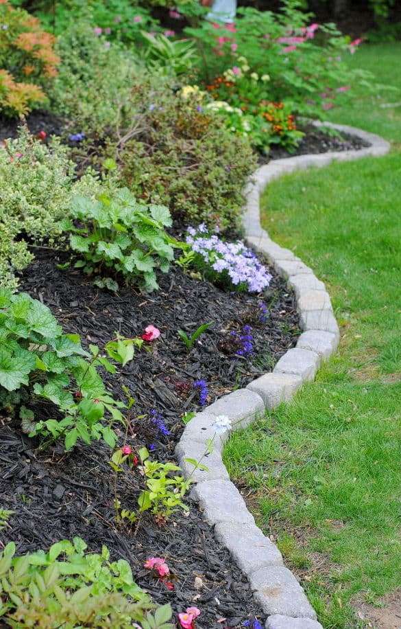 Traditional stone edging always works for most of gardens - it's neutral and timeless, besides it's very durable.