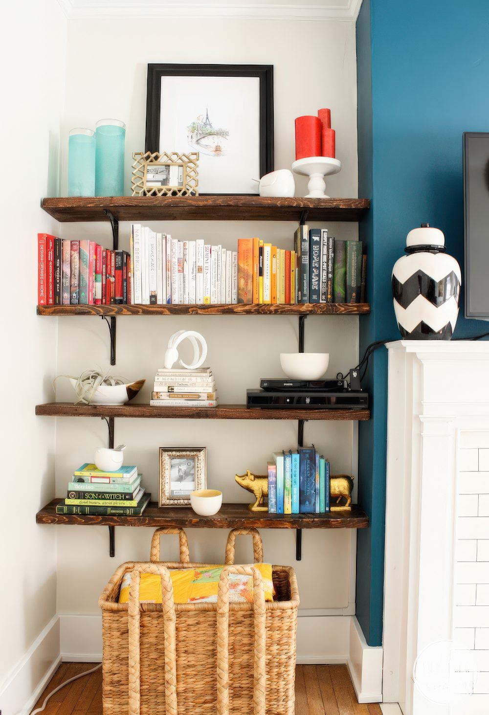 A router placed on a shelf makes part of decor like stacked books is a lovely idea to hide it right in the sight.