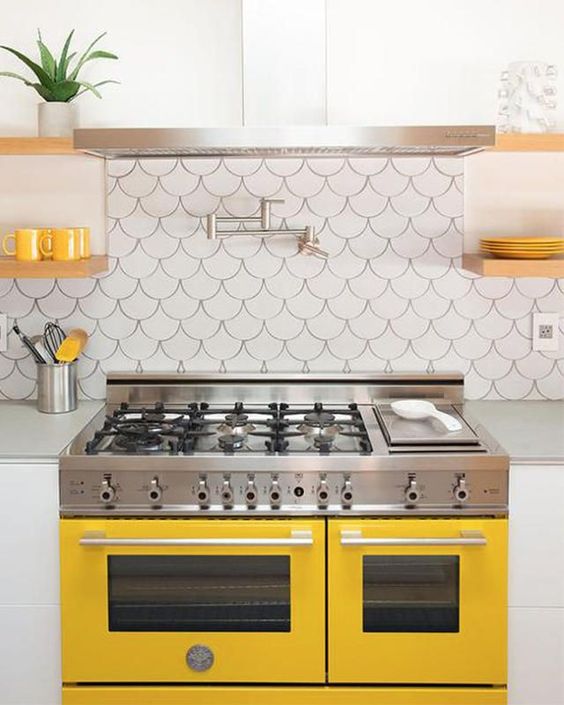 A sunny yellow cooker and matching touches for a chic modern kitchen.