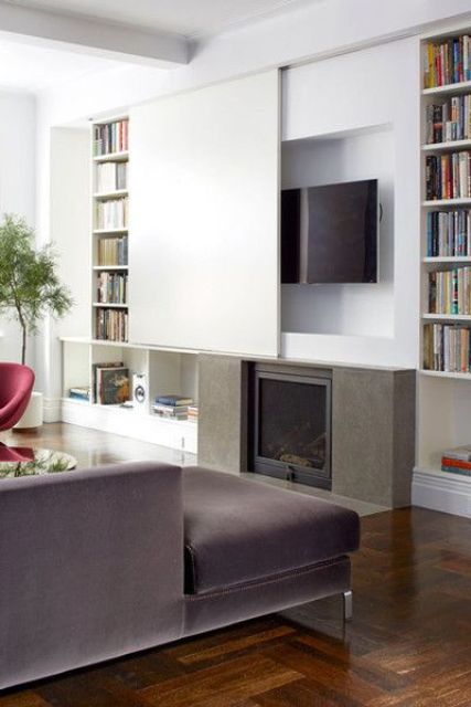 A TV hidden under a white screen that imitates the wall is a clever and rather popular idea - just slide the screen and watch TV.