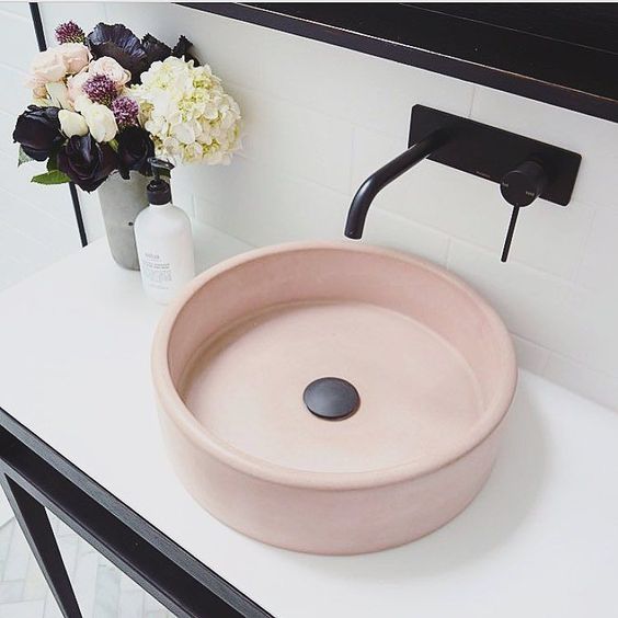 An elegant and refined round blush sink plus black touches for a stylish modenr bathroom.