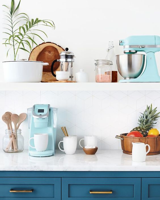 A tiffany blue coffee machine and mixer for a chic blue and brass kitchen.