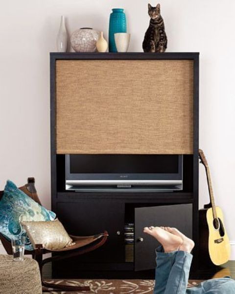 A TV unit with a storage cabinet and a woven shade that can easily hide your TV is a creative modern idea.