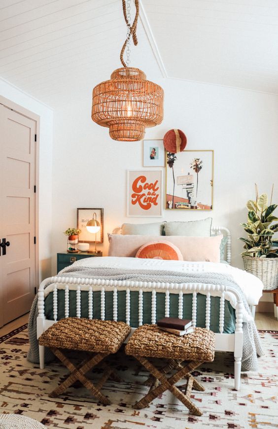 A bright and fun mid-century modern teen bedroom with a white bed and pastel bedding, woven stools, a woven pendant lamp and artwork.