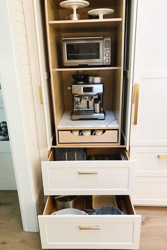 A cabinet with appliances and drawers and various tableware is a stylish solution for any kitchen.