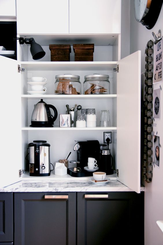 A cabinet with appliances, jars and mugs hidden inside and various stuff turn it into a pretty coffee station is a cool idea.