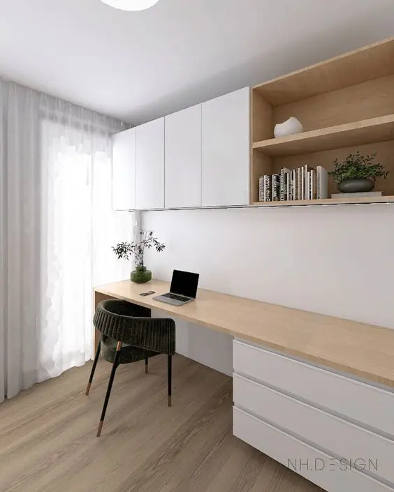 A contemporary home office nook with IKEA Metod cabinets and a large desk with drawers, a comfy chair and some decor.
