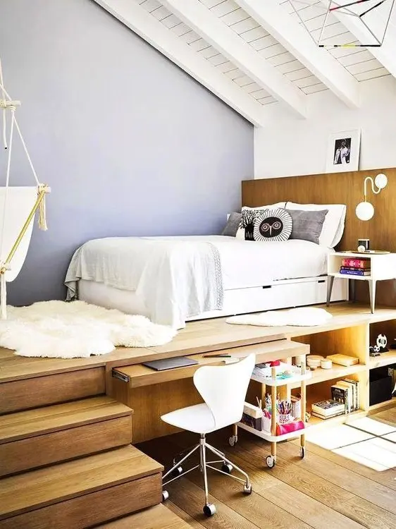 A contemporary teen bedroom with a sleeping space on a platform, a desk space that can be hidden and much storage space.