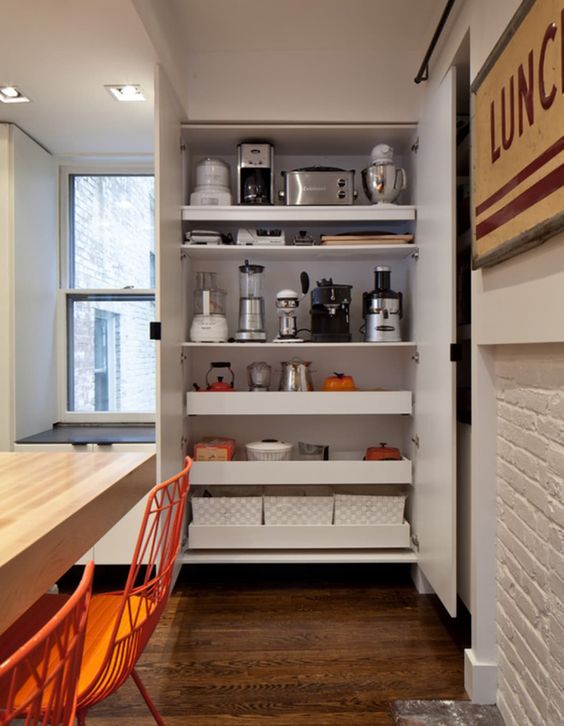 A large storage unit with shelves and drawers, with various appliances and other stuff is a cool idea to hide everything.