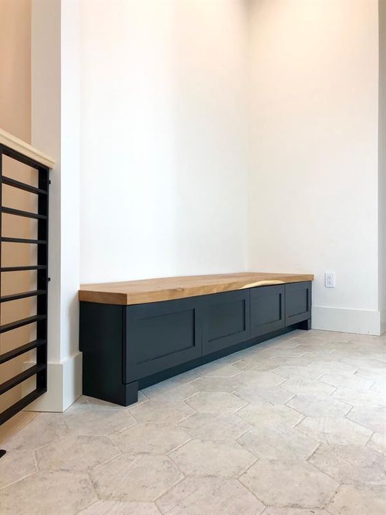 A long black storage bench of IKEA Metod cabinets with a butcherblock countertop is great for a modern space.