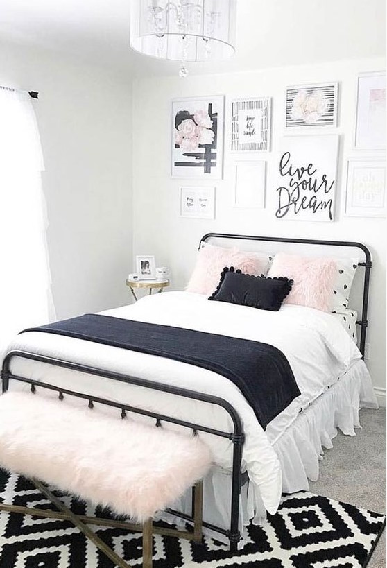 Featuring a pretty gallery wall, this lovely teen bedroom centers around a black metal bed with contrasting bedding. The pink faux fur bench offers a stylish seating option, adding a splash of color and texture to the room.