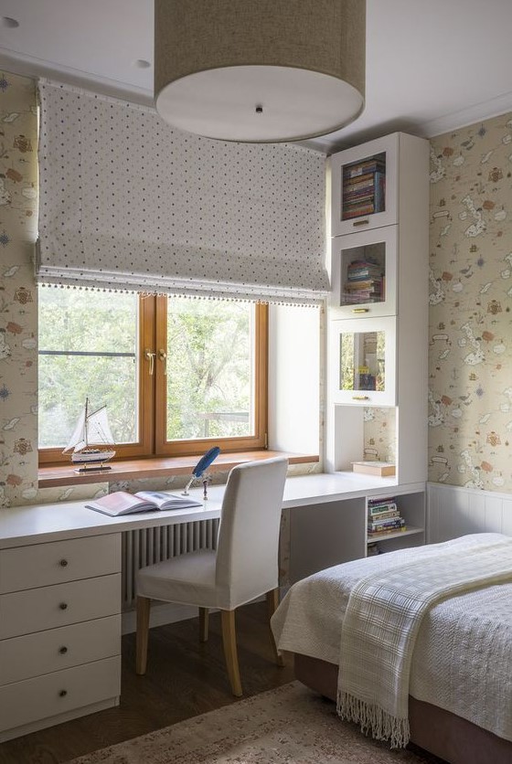 Create a neutral teen room with printed map wallpaper and a built-in desk with storage units. The bed with neutral bedding and a curtain adds comfort and style. This design offers a practical and visually appealing space.