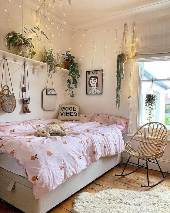 Design a pretty teen room with a storage bed and a shelf filled with potted plants. Lights hanging over the bed and pretty bedding and art add charm and functionality. This room combines practicality with a fresh and inviting look.