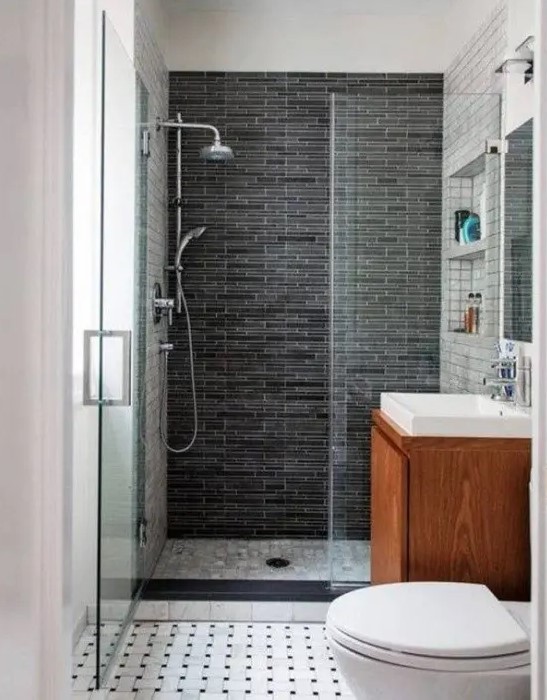 A small modern bathroom with a floating vanity, a shower space with a dark tile wall and a mosaic tile floor.