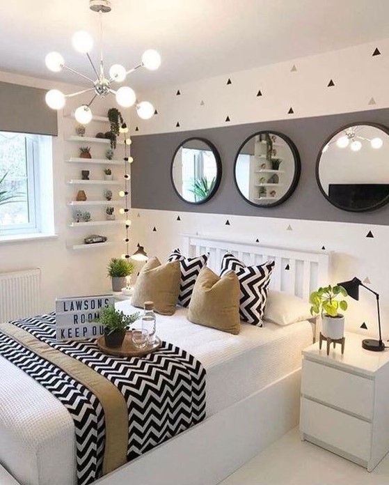 Design a stylish and playful teen girl bedroom in white, grey, and black with tan touches. Geometric prints and greenery bring energy and freshness to the space. This room combines sleek modern design with lively accents.