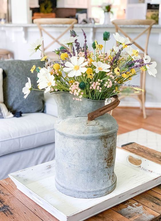 A vintage metal milkpot with wildflowers is a cool summer decoration for any space and it will add a rustic feel.