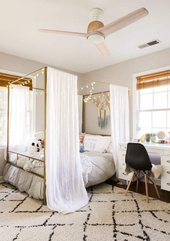 Create a welcoming modern teen girl bedroom featuring a brass canopy bed with lights. Boho decor and various textiles enhance the look. This design combines modern elegance with a cozy atmosphere.