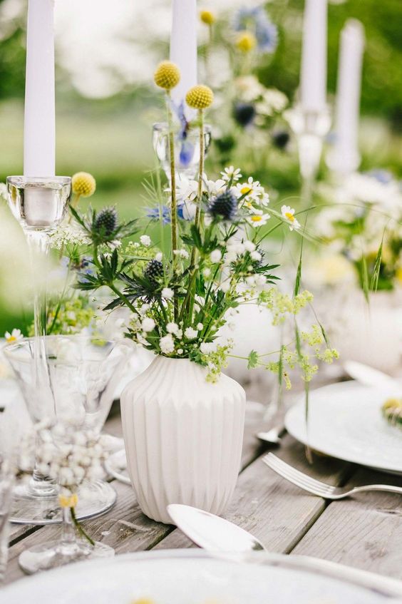 A white patterned vase with wildflowers is a lovely and relaxed summer centerpiece or decoration.