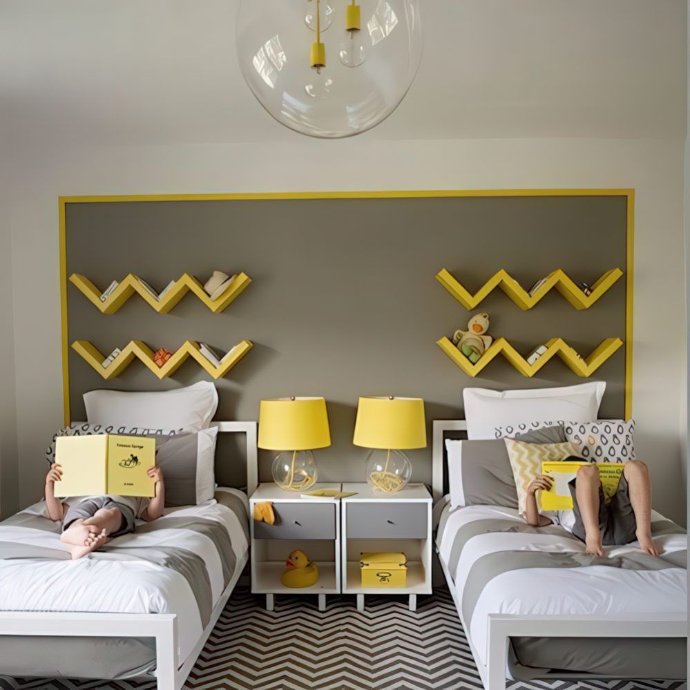 A fresh, modern bedroom with a gray-and-yellow color scheme, angular wall shelving, and a geometric chevron rug. The symmetrical layout and bright yellow décor create a lively yet sophisticated space.