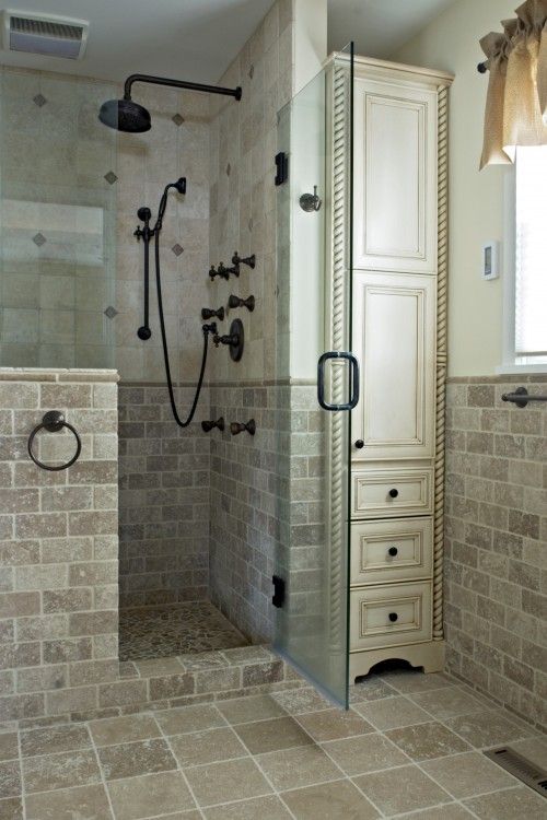A neutral vintage bathroom clad with tiles all over, with a pony wall in the shower space.
