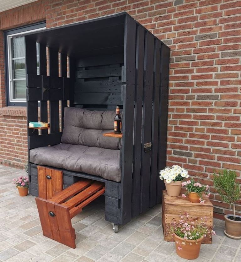 The modern black arbor is done with a seat, shelves and  drawers, under which you can hide something.