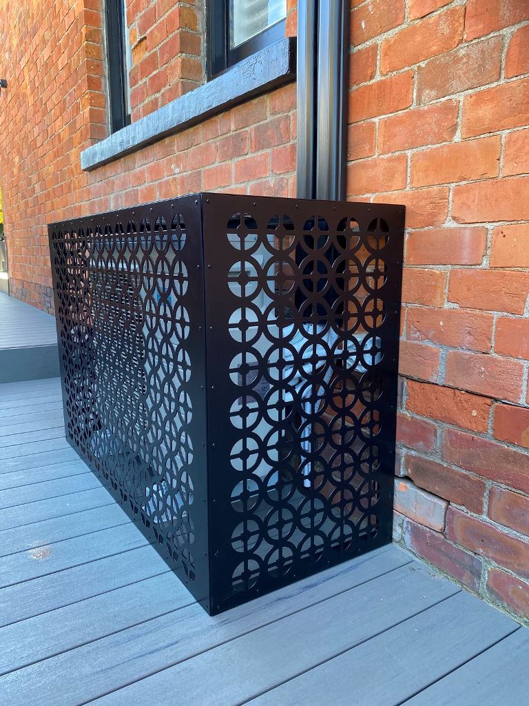 The AC unit cover is made of elegant black metal screens that are laser cut.