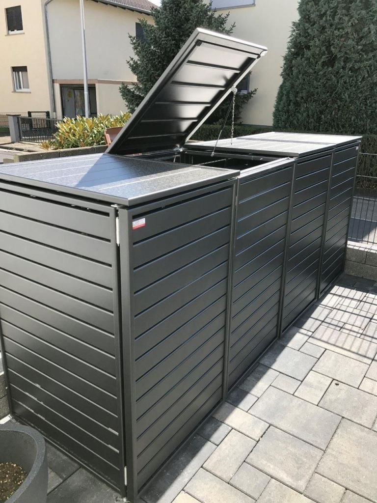 The black slatted boxes with lids can hide all the trash cans you are using.