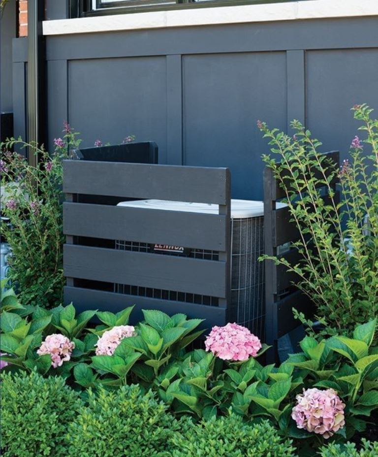 Black wooden screens are great to cover an AC unit, it's a very easy and fast solution.