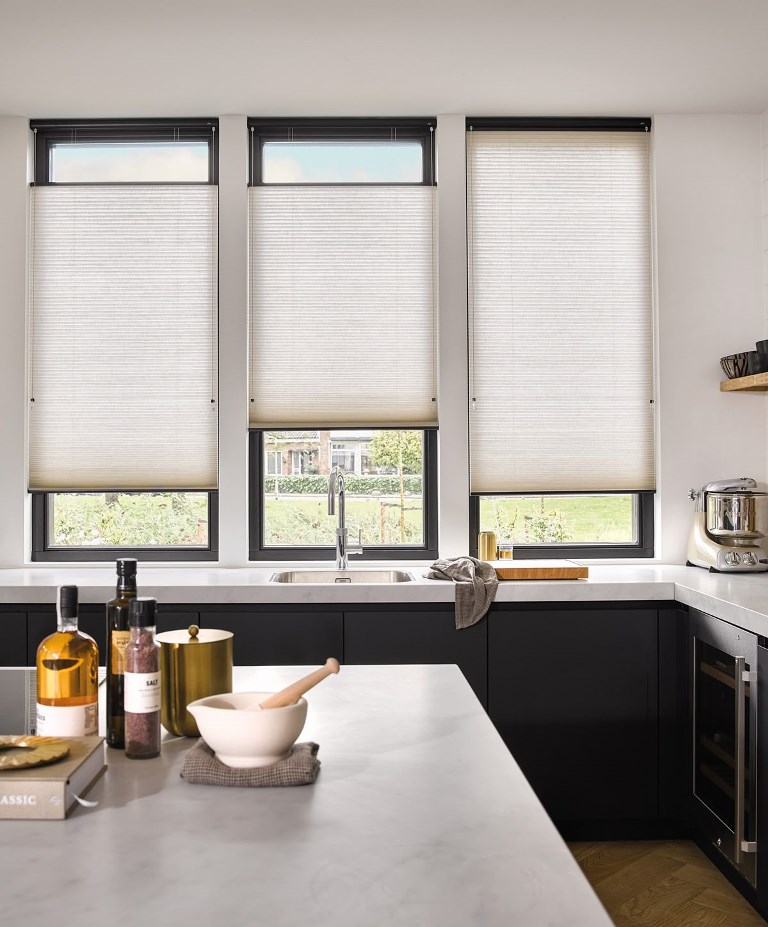 The vertical windows are done with blinds, two of them are covered in the middle, and one in the upper part.