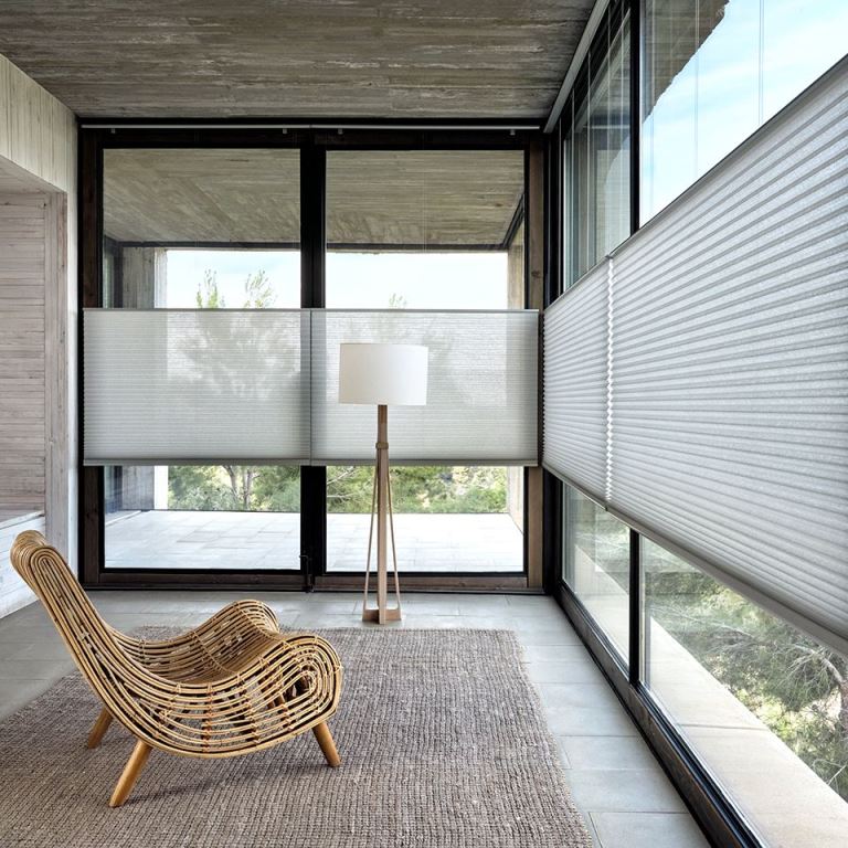 The glazed space features blinds installed in the center of each part, so that bad views were blocked.