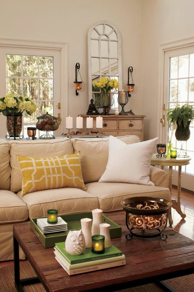 Potted blooms, greenery, touches of yellow and green bring a cheerful summer feel to the living room.