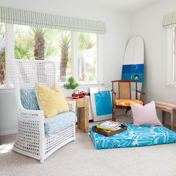 Bright pillows, ottomans, cushions, artworks and greenery for a tropical feel in the living room.