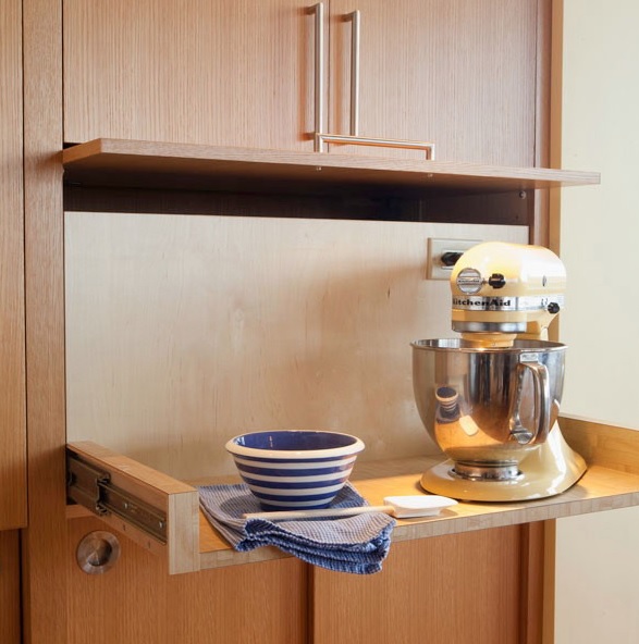 A cabinet with a retracting shelf, a mixer and a bowl helps to hide pieces that you need only from time to time.