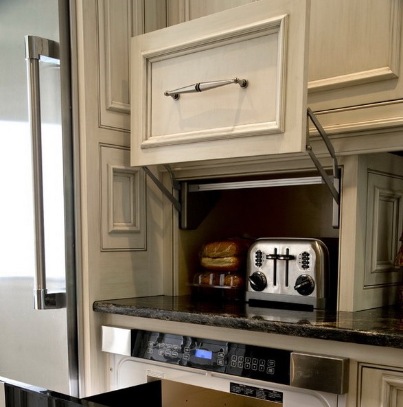 A cabinet with a moving door and a toaster hidden there is a lovely way to keep your kitchen neat.