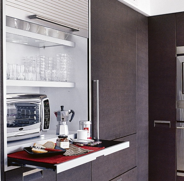 A large cabinet with a shutter cover and usual and retractable shelves with appliances and a microwave allows serving breakfast here.