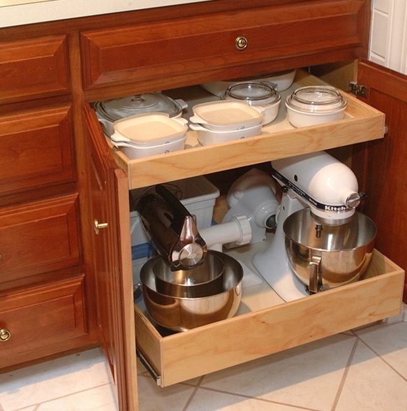 A rich stained lower cabinet with retractable shelves that hold appliances, pots and bowls is a cool idea to declutter the space.