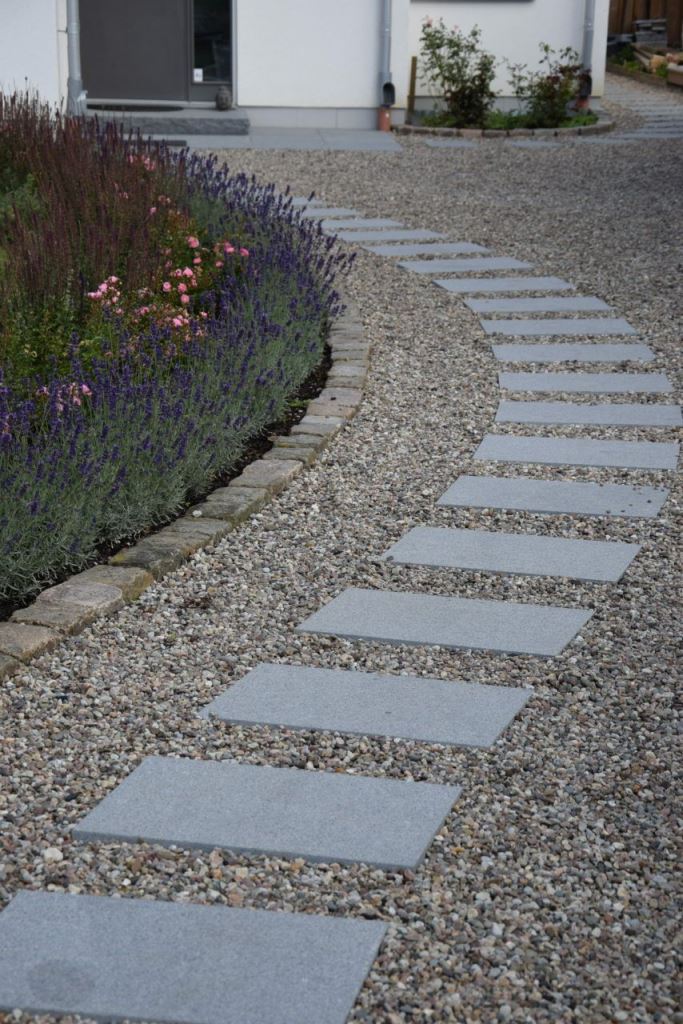 Add curves in a simple way: with pebbles and pavements forming a curved path.