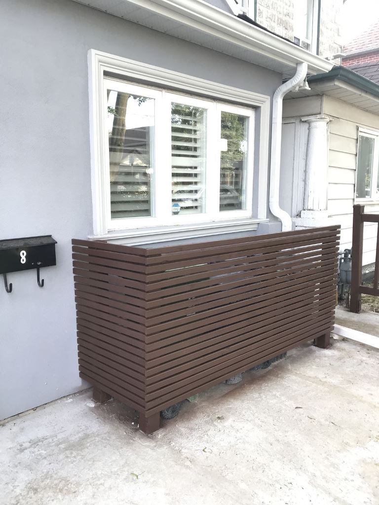 Use several slatted screens to hide all the eye sores: trash cans, AC units and others.