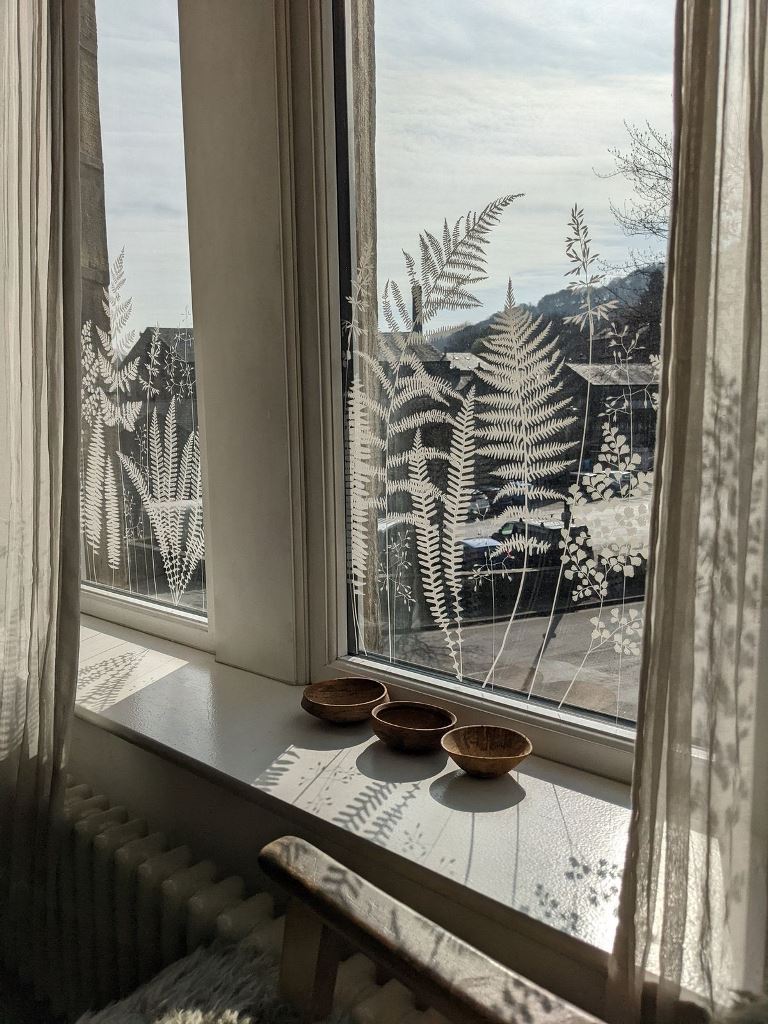 These beautiful botanical decals paired with semi-sheer curtains will not only distract from a bad view but won't block the light. 


(via hannahnunn).